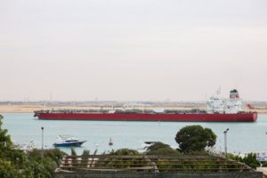 THE RED AND WHITE SKS DOYLES CRUDE OIL TANKER MOVES ALONG THE SUEZ CANAL.