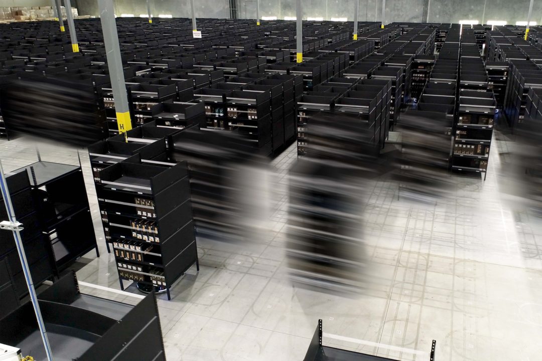 ROBOTS IN A WAREHOUSE ARE BLURRED IN MOTION