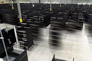 ROBOTS IN A WAREHOUSE ARE BLURRED IN MOTION