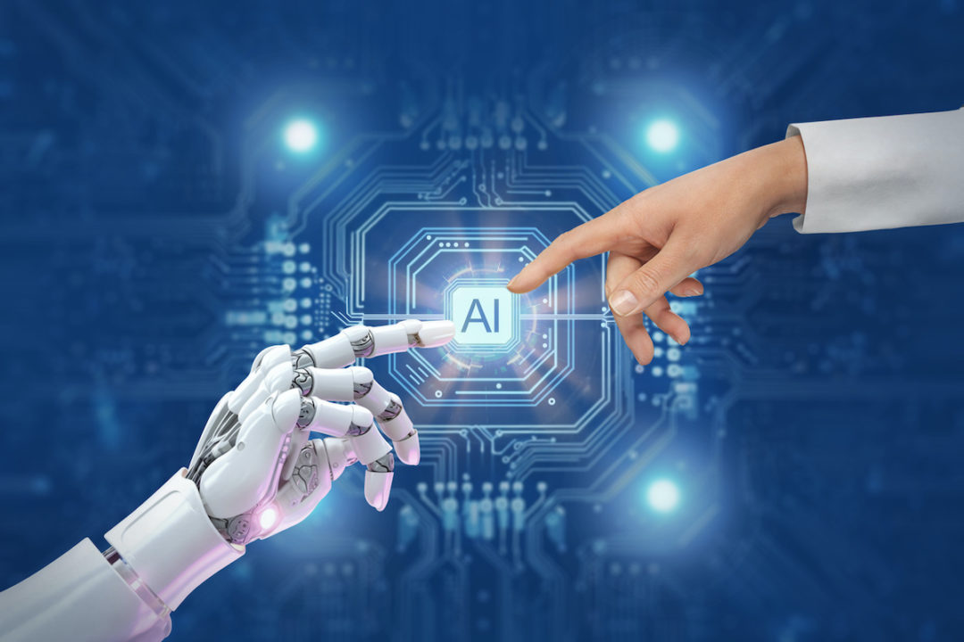 A ROBOTIC ARM AND A HUMAN ARM WEARING A WHITE LAB COAT REACH TOWARD A SYMBOL LABELED "AI."