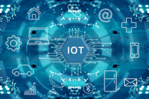 A HEXAGON WITH THE LETTERS "IOT" IN IT IS SURROUNDED BY MANY DIGITIZED SYMBOLS AND IMAGES.