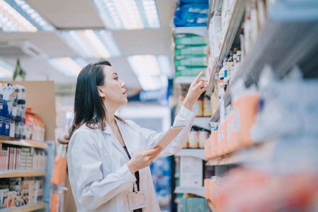 A female Pharmacist checks inventory on a shelf