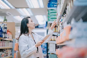 A female Pharmacist checks inventory on a shelf