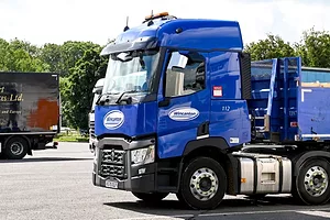 A BRIGHT BLUE TRUCK CAB BEARS THE WINCANTON LOGO