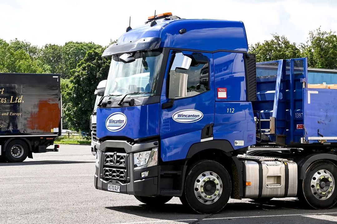 A BRIGHT BLUE TRUCK CAB BEARS THE WINCANTON LOGO