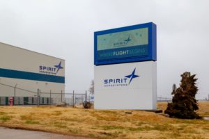 A LARGE SIGN OUTSIDE AN OFFICE BUILDING READS SPIRIT AEROSYSTEMS