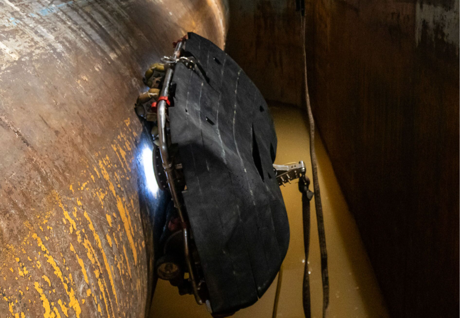 A robot built to simulate the curvature of a ship's hull and muddy water conditions.