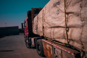 A truck carrying large, canvas-covered humanitarian aid packages at the Israel-Gaza Kerem Shalom border crossing.