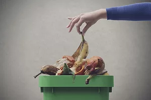 Old food in a green trash can