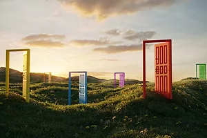 A WHIMSICAL LANDSCAPE HAS MANY COLORED, OPEN DOORS.