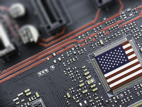 An American flag laid over a semiconductor chip