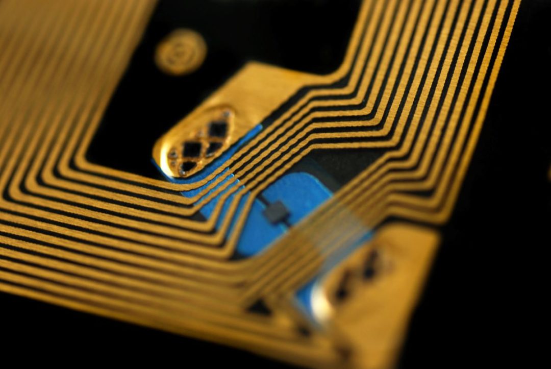 EXTREME CLOSEUP OF AN RFID TAG SHOWING PARALLEL RIBBONS OF METAL.