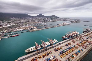 A PANORAMIC VIEW OF A HARBOR PORT, WITH MOUNTAINS BEHIND