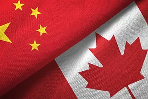 The Chinese and Canadian flags juxtaposed against each other diagonally