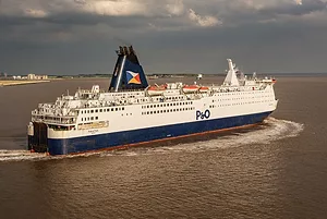 A FERRY BEARING THE P&O INSIGNIA CROSSES THE SEA UNDER A CLOUDY SKY