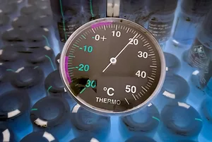 A round-faced dial refrigerator thermometer in cold storage unit