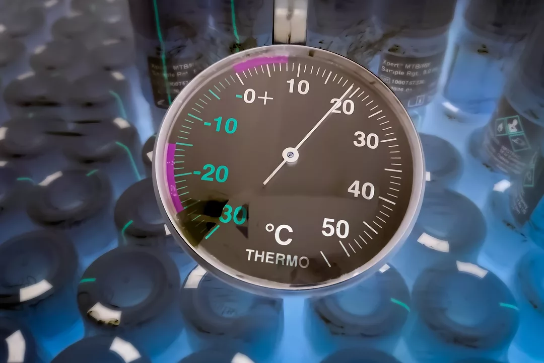 A round-faced dial refrigerator thermometer in cold storage unit