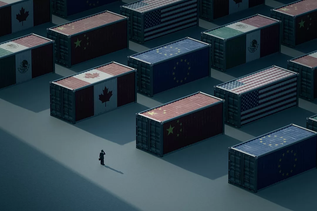 A black silhouetted man standing in front of rows of shadowed shipping containers, each bearing the flag of a different country