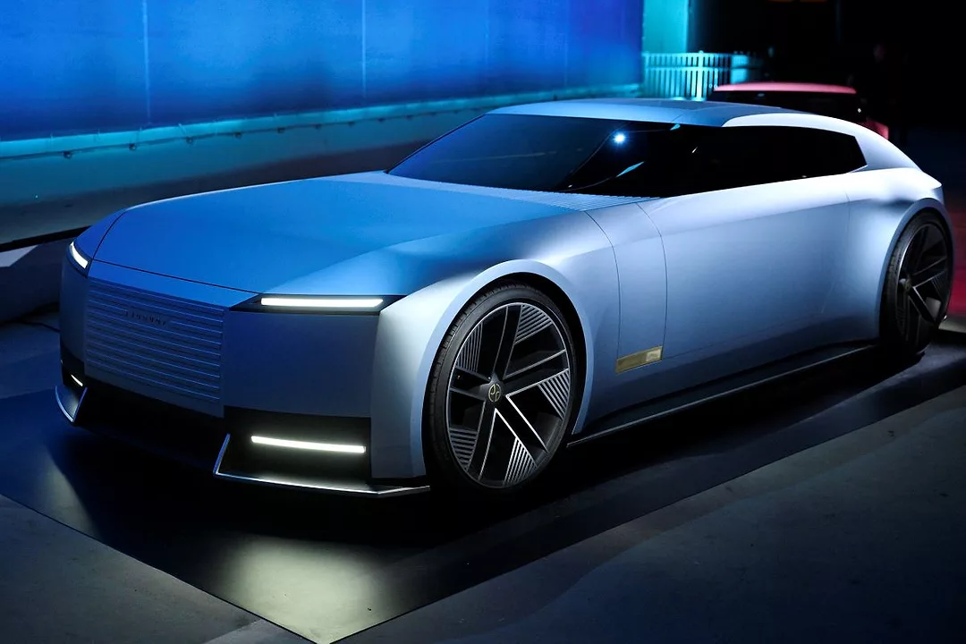 A SLEEK, FANCY CAR GLEAMS UNDER BLUE SHOWROOM LIGHTS