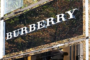 White lettering that reads "Burberry" over the top of a glass storefront