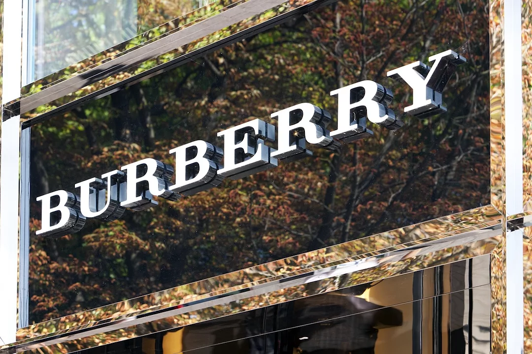 White lettering that reads "Burberry" over the top of a glass storefront