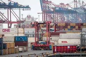 A BUSY OCEAN CONTAINER TERMINAL WITH CRANES AND DOCKS