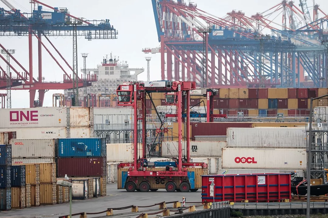 A BUSY OCEAN CONTAINER TERMINAL WITH CRANES AND DOCKS