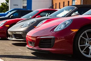 A ROW OF SPORTS CARS SPARKLES IN THE SUN