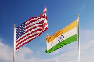 American and Indian Flags Waving in Different Directions Over Blue Sky