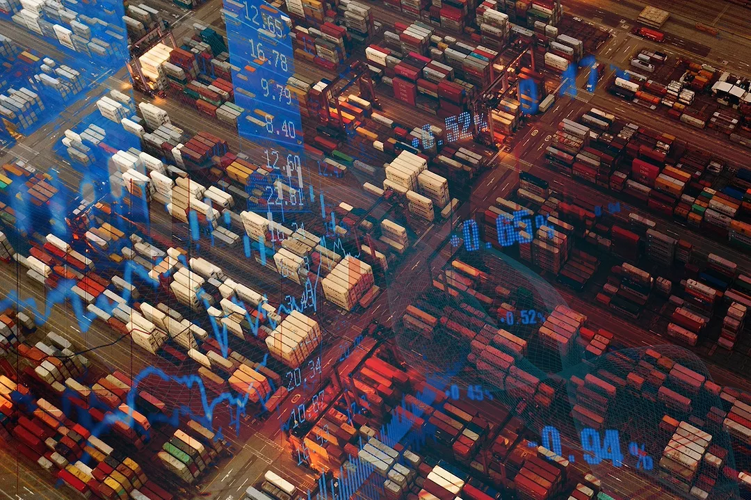 An overhead view of stacks of multi-colored shipping containers, with a blue graphic overlayed depicting a series of numbers