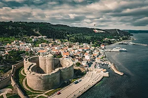 AN ANCIENT CASTLE LOOMS OVER A STRETCH OF SEA
