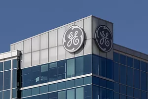A GLASS AND STEEL OFFICE BUILDING BEARS THE GE LOGO