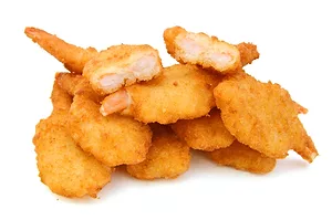 A CLUSTER OF DEEP-FRIED, BREADED SHRIMP SITS IN A WHITE SPACE