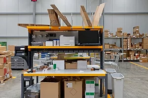 A PACKING STATION SITS IN A WAREHOUSE