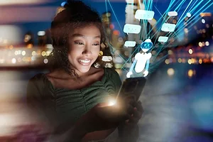 A woman interacts with smart phone with futuristic transparent screen displaying chatbot and text clouds