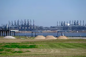 AN INDUSTRIAL FACILITY IS VIEWED ACROSS A RIVER