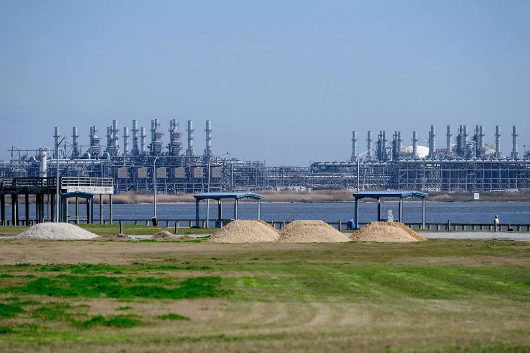 AN INDUSTRIAL FACILITY IS VIEWED ACROSS A RIVER