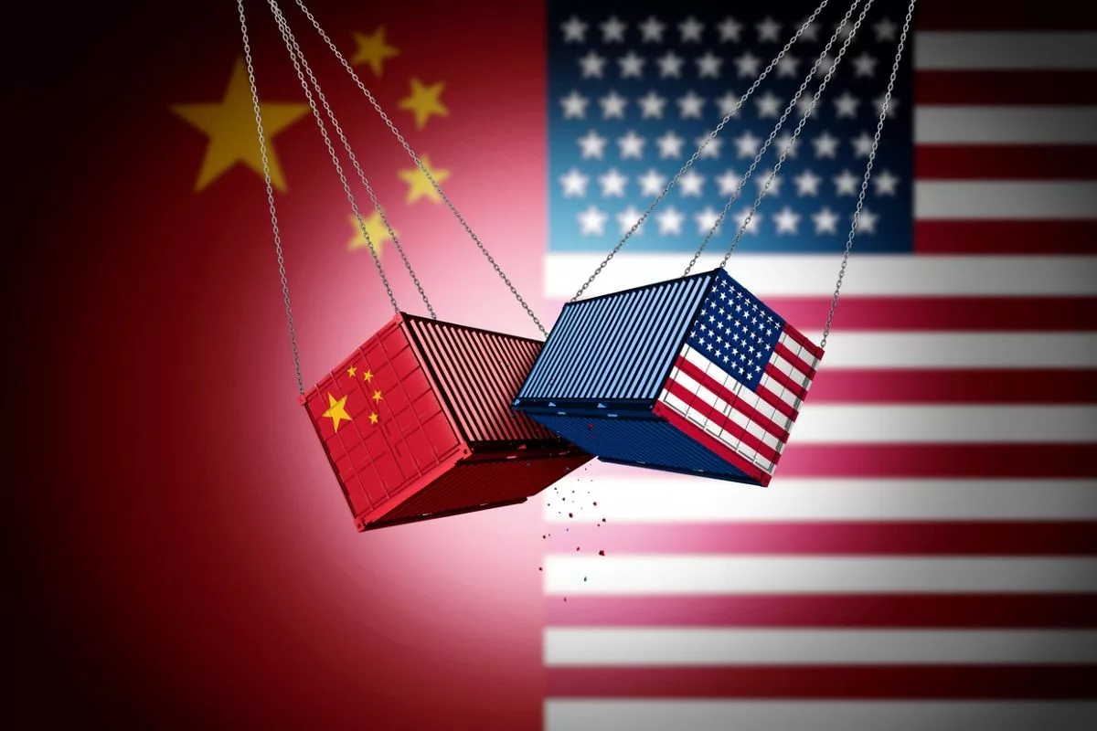 SHIPPING CONTAINERS BEARING THE FLAGS OF THE US AND CHINA SWING AND CLASH IN MIDAIR