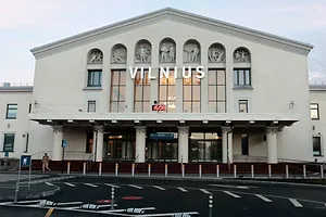 The exterior of a white building with seven rows of narrow vertical windows, with "VILNIUS" printed on the front in large white lettering