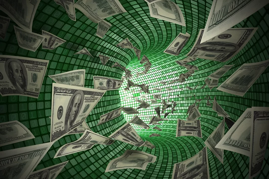 A GRAPHIC IMAGE SHOWS A CURVED, GLEAMING FUNNEL WITH DOLLAR BILLS BEING SUCKED DOWN IT