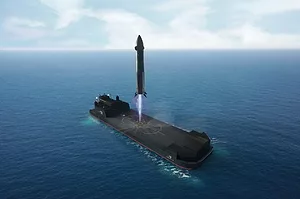A ROCKET LANDS ON A BARGE AT SEA