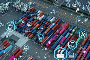 MULTI-COLORED CONTAINERS SIT ON A DOCK, OVERLAID WITH DIGITAL TRACKING IMAGES