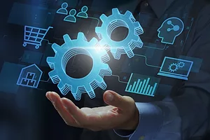 AN IMAGE WITH A HAND HOLDING FLOATING ICONS OF WHEEL COGS AND SOURCES OF DATA