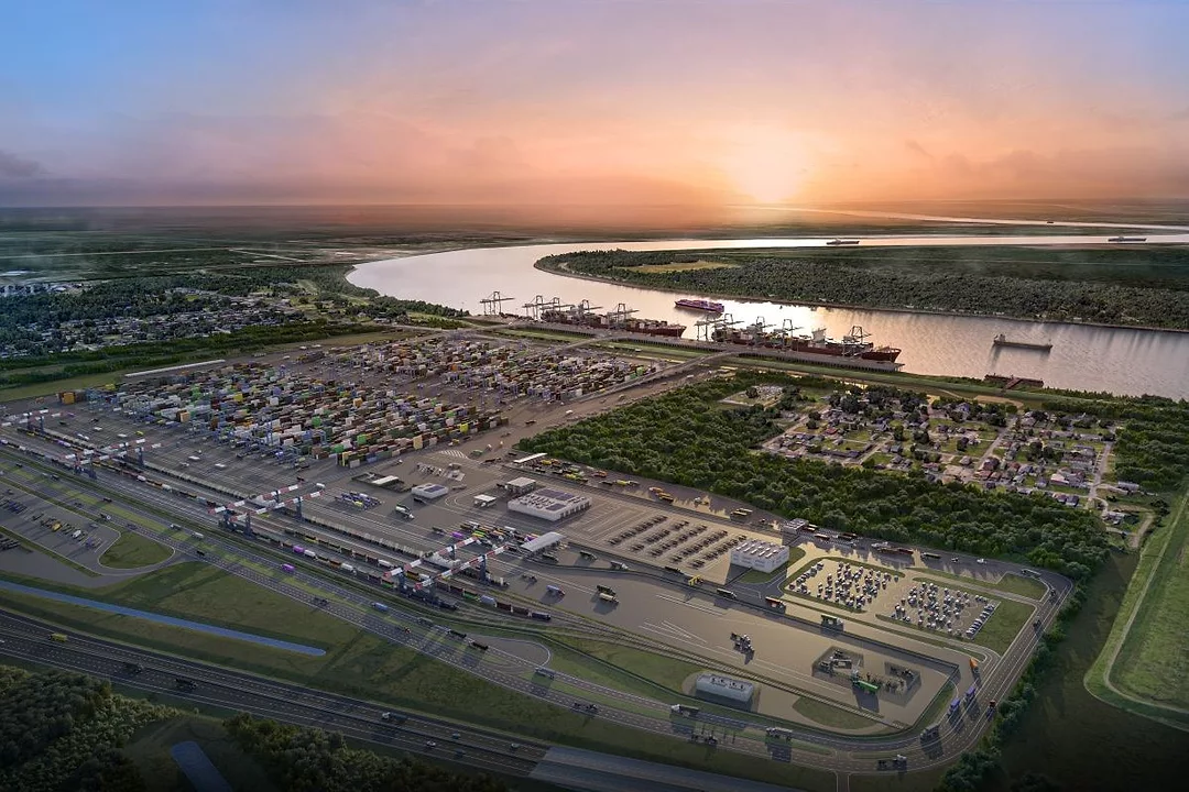 A LARGE MARINE TERMINAL ON THE EDGE OF A WIDE RIVER GLEAMS IN THE LIGHT OF A SETTING SUN
