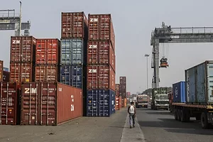 CONTAINERS SIT IN STACKS IN A PORT