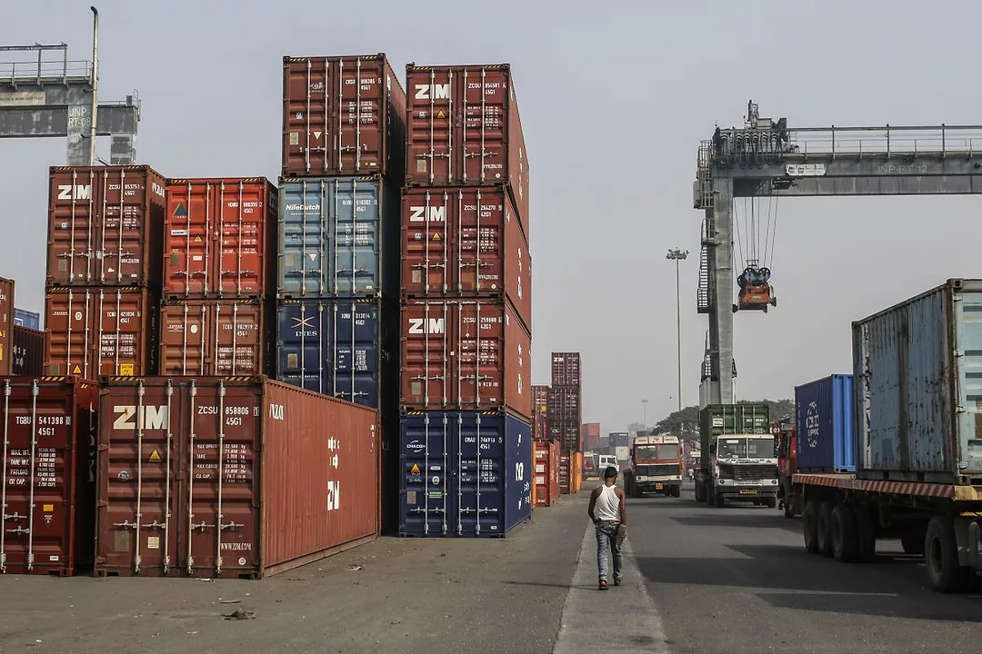 CONTAINERS SIT IN STACKS IN A PORT