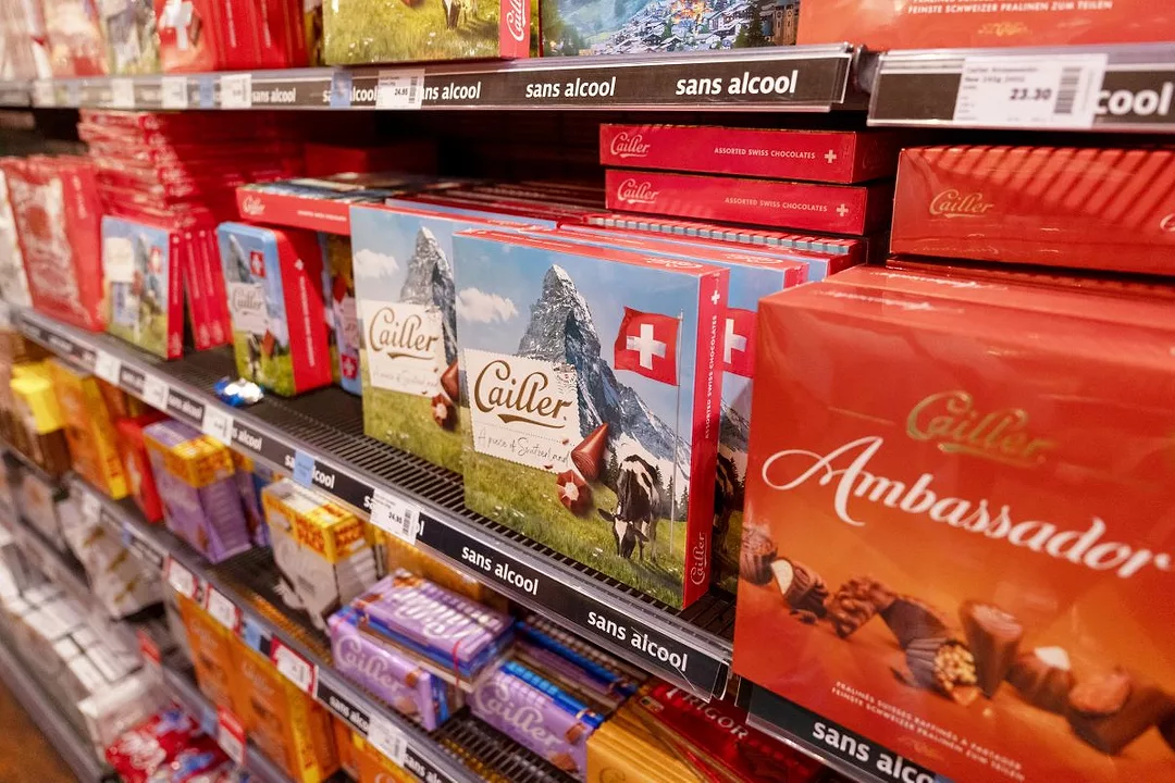 A GROCERY SHELF PILED WITH SWISS CHOCOLATE BRANDS