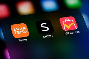 A SMARTPHONE SCREEN DISPLAYS THE LOGOS OF TEMU AND SHEIN