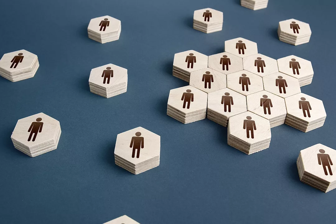 A group of hexagonal tiles, each depicting a man, grouped together on a navy blue surface