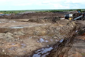 THE SCARS IN THE EARTH OF AN OPEN CAST MINE SITS UNDER A CLOUDY SKY